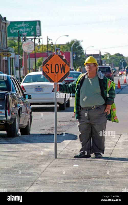 asphalt-paving-of-a-street-using-heavy-machinery-with-man-directing-APKPA1.jpg