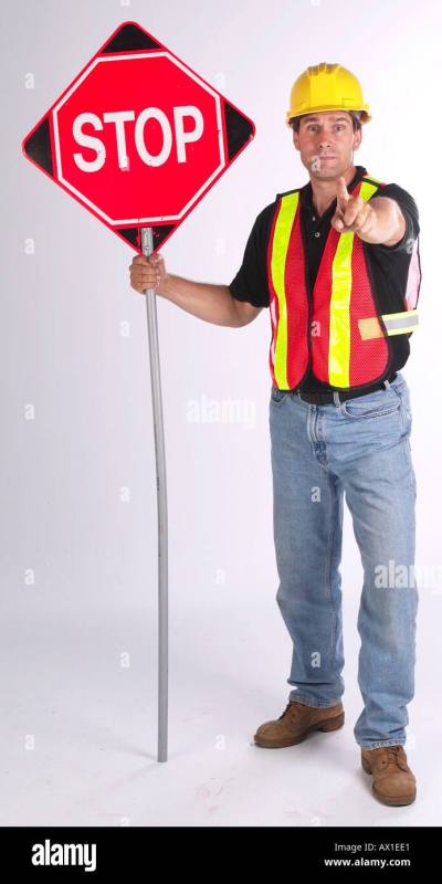construction-worker-holding-out-stop-sign-AX1EE1.jpg